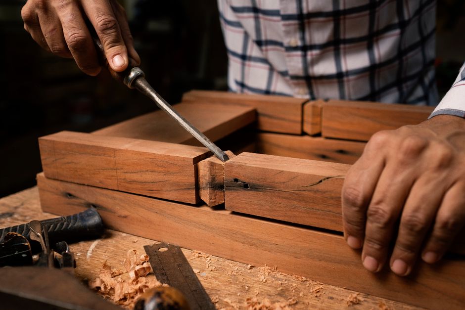 Artisan woodworker meticulously crafting custom furniture in the workshop